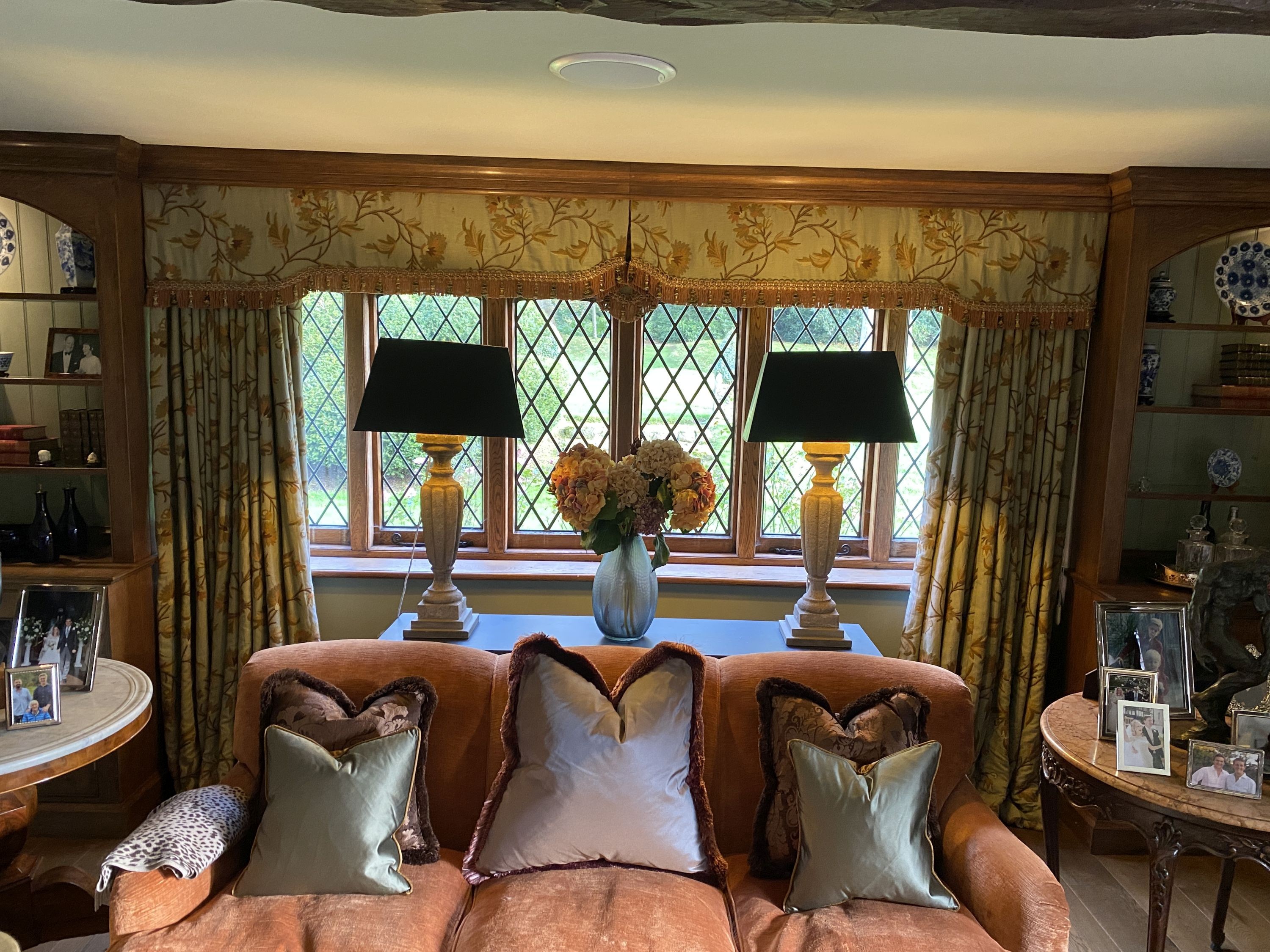 A pair of eau de nil linen curtains with floral crewel work decoration, and matching two piece pelmet, drop 230cm, generously made to fit an aperture of 3.6m